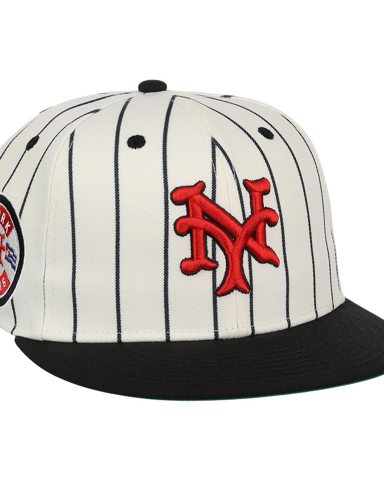 The EFF New York Cubans NLB Pinstripe Fitted Ballcap features white fabric with black pinstripes, a black brim, red interlocking NY logo, and a side patch—honoring the legacy of Black baseball and the Negro National League.