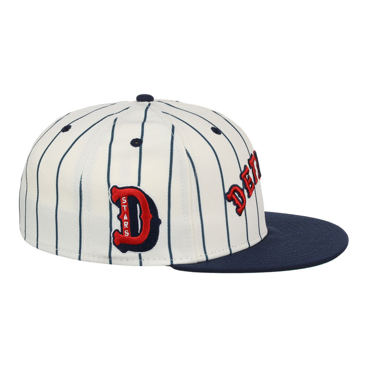 The EFF Detroit Stars NLB Pinstripe Fitted Ballcap features white fabric with black pinstripes, a navy brim, and red-and-black embroidered “D” and DETROIT Stars on the side, honoring the Negro National League.