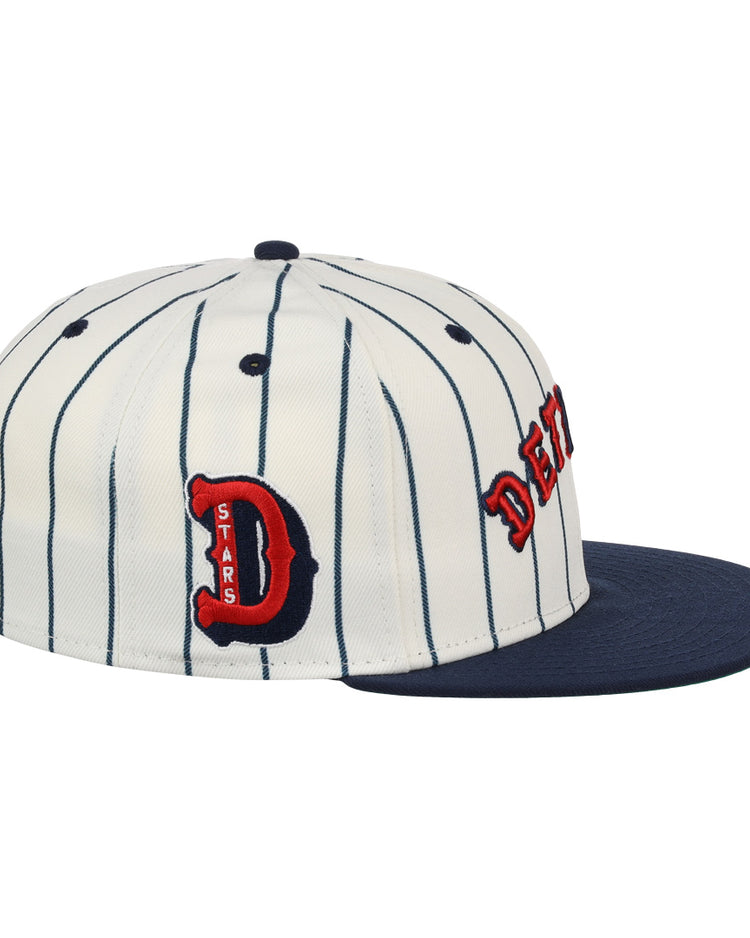 The EFF Detroit Stars NLB Pinstripe Fitted Ballcap features white fabric with black pinstripes, a navy brim, and red-and-black embroidered “D” and DETROIT Stars on the side, honoring the Negro National League.
