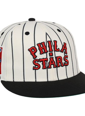 The EFF Philadelphia Stars NLB Pinstripe Fitted Ballcap features a white design with black pinstripes, a black brim, red PHILA STARS embroidery, and a side patch honoring the Negro National League Centennial 1920-2020.