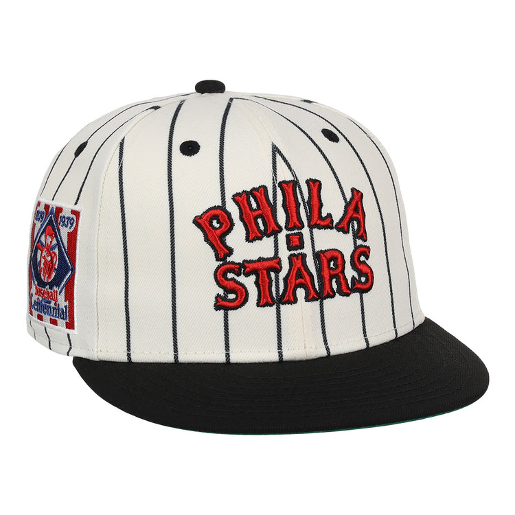 The EFF Philadelphia Stars NLB Pinstripe Fitted Ballcap features a white design with black pinstripes, a black brim, red PHILA STARS embroidery, and a side patch honoring the Negro National League Centennial 1920-2020.
