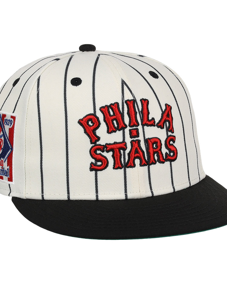 The EFF Philadelphia Stars NLB Pinstripe Fitted Ballcap features a white design with black pinstripes, a black brim, red PHILA STARS embroidery, and a side patch honoring the Negro National League Centennial 1920-2020.