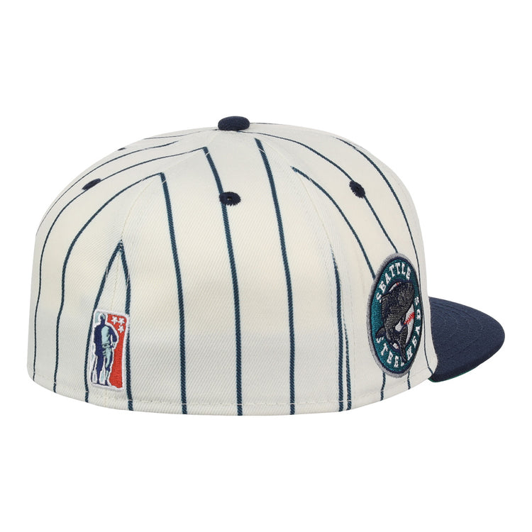 The EFF Seattle Steelheads NLB Pinstripe Fitted Ballcap features white and navy pinstripes, a navy brim, a round bear patch with text, and a small patch of a figure holding a bat.