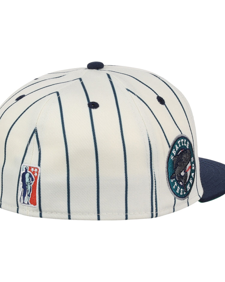 The EFF Seattle Steelheads NLB Pinstripe Fitted Ballcap features white and navy pinstripes, a navy brim, a round bear patch with text, and a small patch of a figure holding a bat.