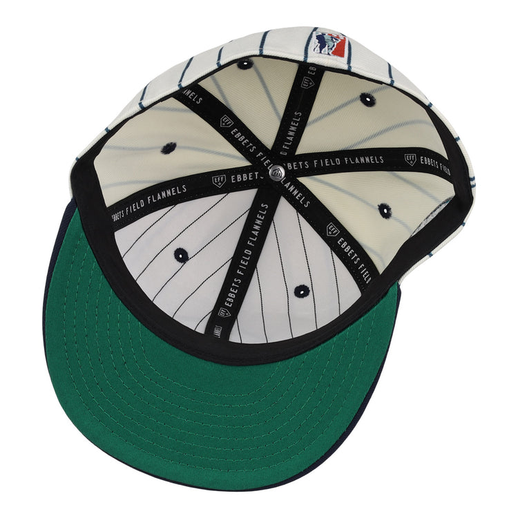 The inside of the Seattle Steelheads NLB Pinstripe Fitted Ballcap by EFF features white fabric with black pinstripes, a green underbrim, and black bands labeled EBBETS FIELD FLANNELS.