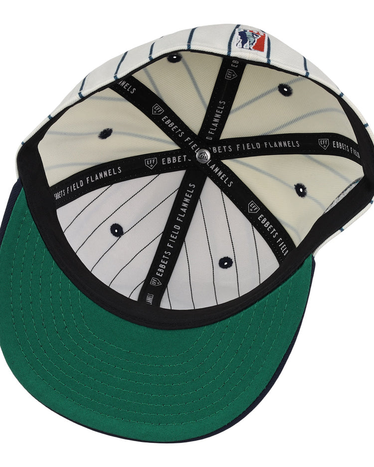 The inside of the Seattle Steelheads NLB Pinstripe Fitted Ballcap by EFF features white fabric with black pinstripes, a green underbrim, and black bands labeled EBBETS FIELD FLANNELS.