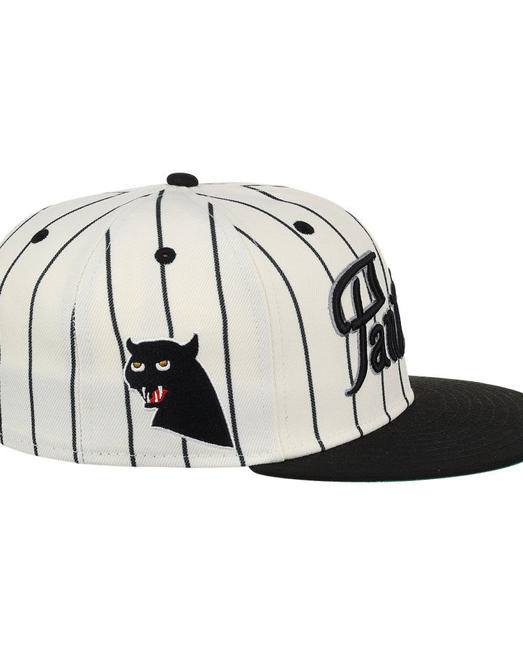 The EFF Montreal Black Panthers NLB Pinstripe Fitted Ballcap features black vertical pinstripes on white, a black brim, and an embroidered black cat face with red eyes and fangs on the side.