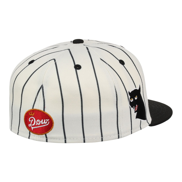 The EFF Montreal Black Panthers NLB Pinstripe Fitted Ballcap features black vertical pinstripes, a black brim, a red oval Pow patch on the side, and a small cartoon cat face with fangs near the front—ideal for Panthers fans.