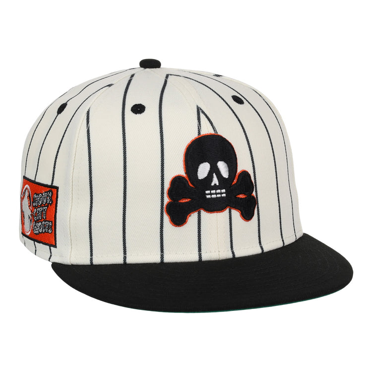The EFF Sioux City Ghosts Pinstripe Fitted Ballcap features a white base with black vertical pinstripes, a black brim, a skull and crossbones patch on the front, and an orange rectangular graphic patch on the left side.
