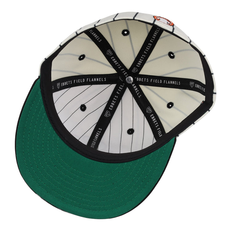 The Sioux City Ghosts EFF Pinstripe Fitted Ballcap by EFF is shown from below, displaying its black-and-white pinstripes, green underbrim, and black interior taping labeled EBBETS FIELD FLANNELS.