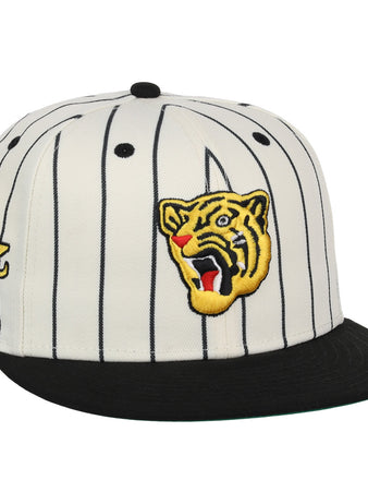 The Osaka Tigers EFF Pinstripe Fitted Ballcap by EFF features a white design with black pinstripes, a black brim, and embroidered patches—like a roaring tiger head—that honor Black baseball history.