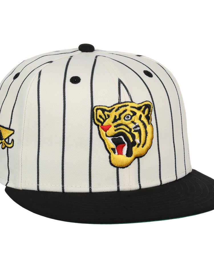 The Osaka Tigers EFF Pinstripe Fitted Ballcap by EFF features a white design with black pinstripes, a black brim, and embroidered patches—like a roaring tiger head—that honor Black baseball history.