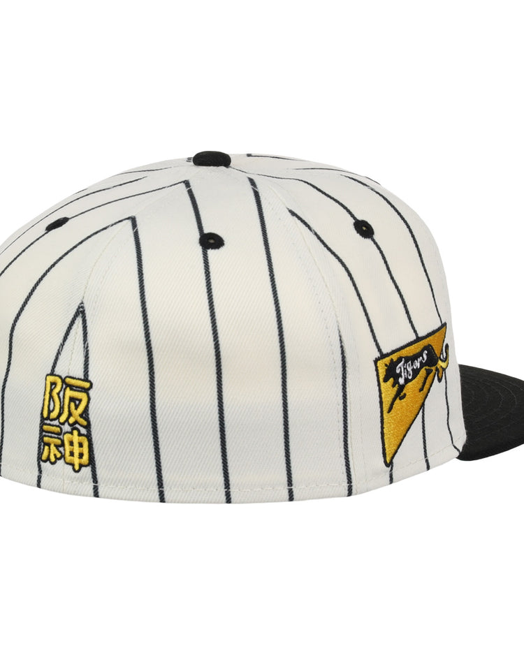 The EFF Osaka Tigers EFF Pinstripe Fitted Ballcap features a white design with black pinstripes, a black brim, yellow Japanese characters on the side, and a yellow pennant patch with Tigers from the NLB Pinstripe Collection.