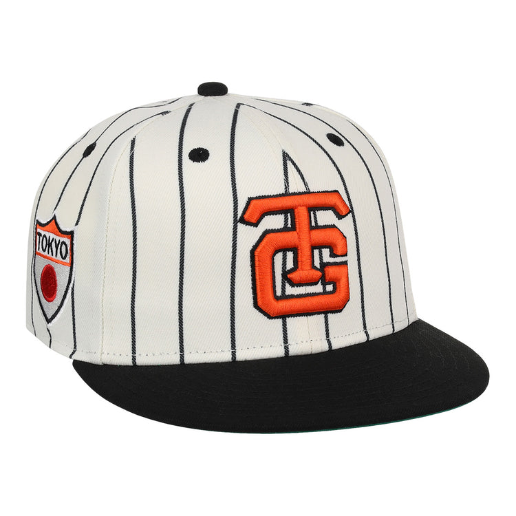 The EFF Tokyo Giants EFF Pinstripe Fitted Ballcap features white fabric with black vertical pinstripes, a black brim, an orange TG logo, and a Tokyo patch—perfect for fans of the NLB Pinstripe Collection.