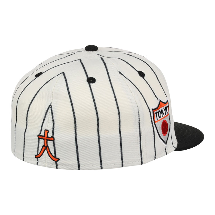 The EFF Tokyo Giants EFF Pinstripe Fitted Ballcap features black pinstripes on white, a black brim, and two embroidered patches: an orange Japanese character and a Tokyo shield badge with a red circle.