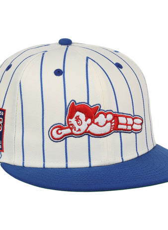The EFF Sankei Atoms EFF Pinstripe Fitted Ballcap is a white cap with blue pinstripes, a blue brim, side patch, and red and white Atom Boy logo in a flying pose embroidered on the front.