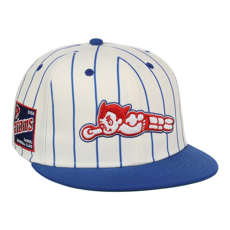 The EFF Sankei Atoms EFF Pinstripe Fitted Ballcap is a white cap with blue pinstripes, a blue brim, side patch, and red and white Atom Boy logo in a flying pose embroidered on the front.