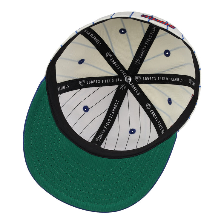 The underside of the Sankei Atoms EFF Pinstripe Fitted Ballcap by EFF features a green brim, white pinstriped inner lining with blue dots, a black band, and repeated EBBETS FIELD FLANNELS print inside.