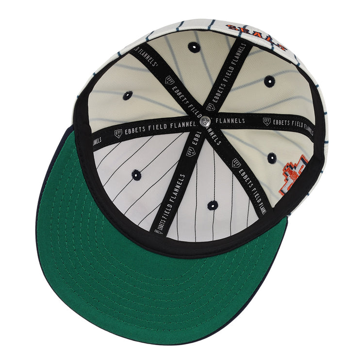 Inside view of the San Francisco Seals Pinstripe Fitted Ballcap by EFF, featuring white and black pinstripes, black inner seams labeled EBBETS FIELD FLANNELS, and a green brim underside.