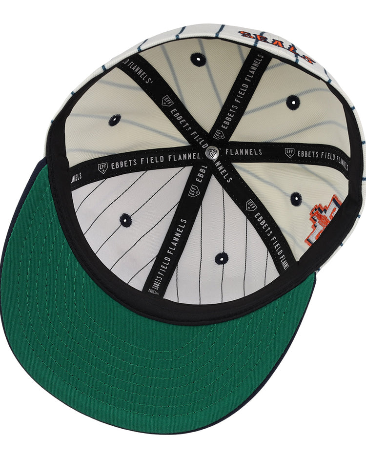 Inside view of the San Francisco Seals Pinstripe Fitted Ballcap by EFF, featuring white and black pinstripes, black inner seams labeled EBBETS FIELD FLANNELS, and a green brim underside.