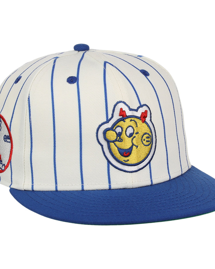 The EFF Reddy Kilowatt EFF Pinstripe Fitted Ballcap features a white base with blue pinstripes, a blue brim, and playful patches, including a smiling yellow Reddy Kilowatt face with red horns and a circular patch on the side.