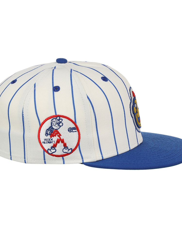 The EFF Reddy Kilowatt EFF Pinstripe Fitted Ballcap is white with blue pinstripes, a blue brim, and features embroidered bear swinging bat and colorful logo patches on the front.