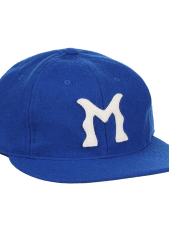 The EFF Montreal Royals 1954 Vintage Ballcap is a blue wool cap with a white, stylized M—replicating the iconic look worn by legends like Roberto Clemente.