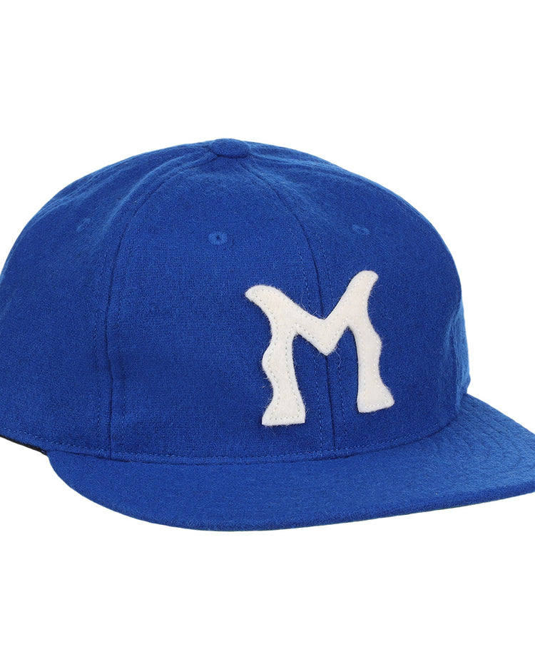 The EFF Montreal Royals 1954 Vintage Ballcap is a blue wool cap with a white, stylized M—replicating the iconic look worn by legends like Roberto Clemente.
