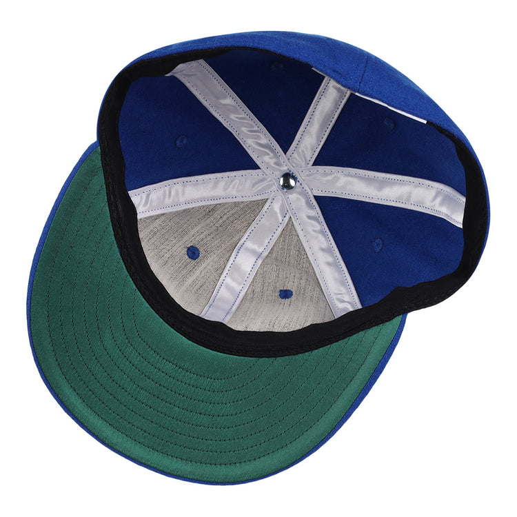 The image shows the interior of the EFF Montreal Royals 1954 Vintage Ballcap, featuring a green underbrim, white seam bands, and a black inner band at the base.