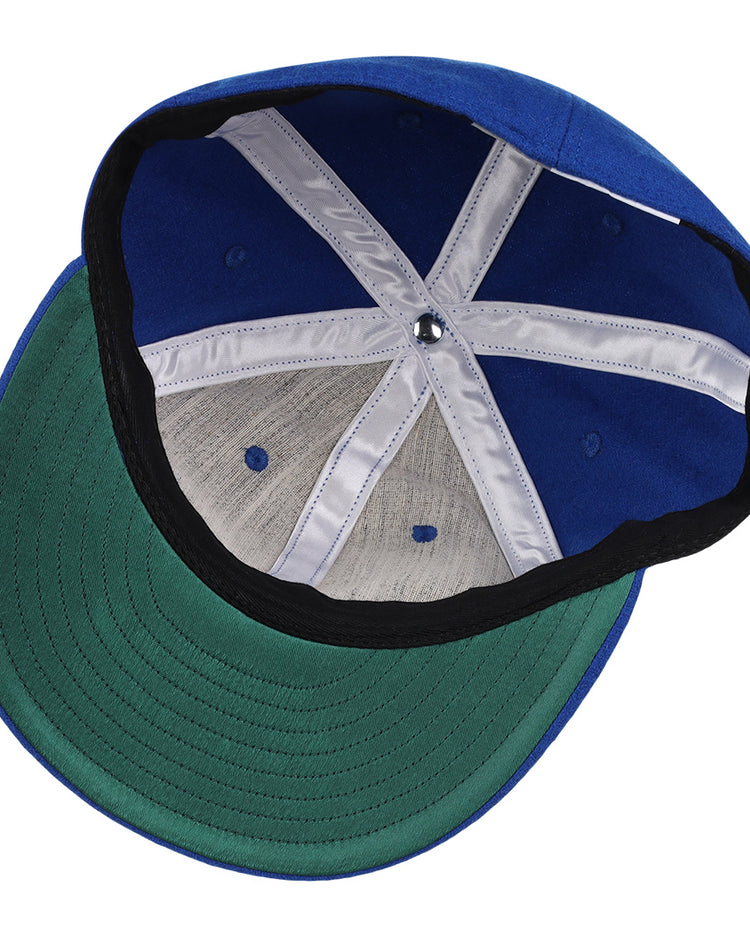 The image shows the interior of the EFF Montreal Royals 1954 Vintage Ballcap, featuring a green underbrim, white seam bands, and a black inner band at the base.