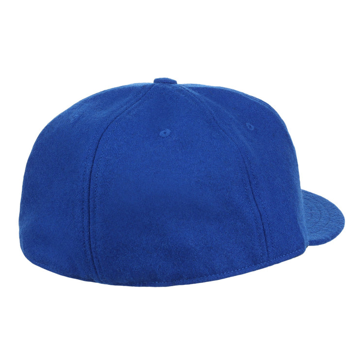 The EFF Montreal Royals 1954 Vintage Ballcap, crafted in genuine wool, is a plain royal blue cap shown from the back—with no logos or adjustable strap—evoking the classic style once worn by Roberto Clemente.