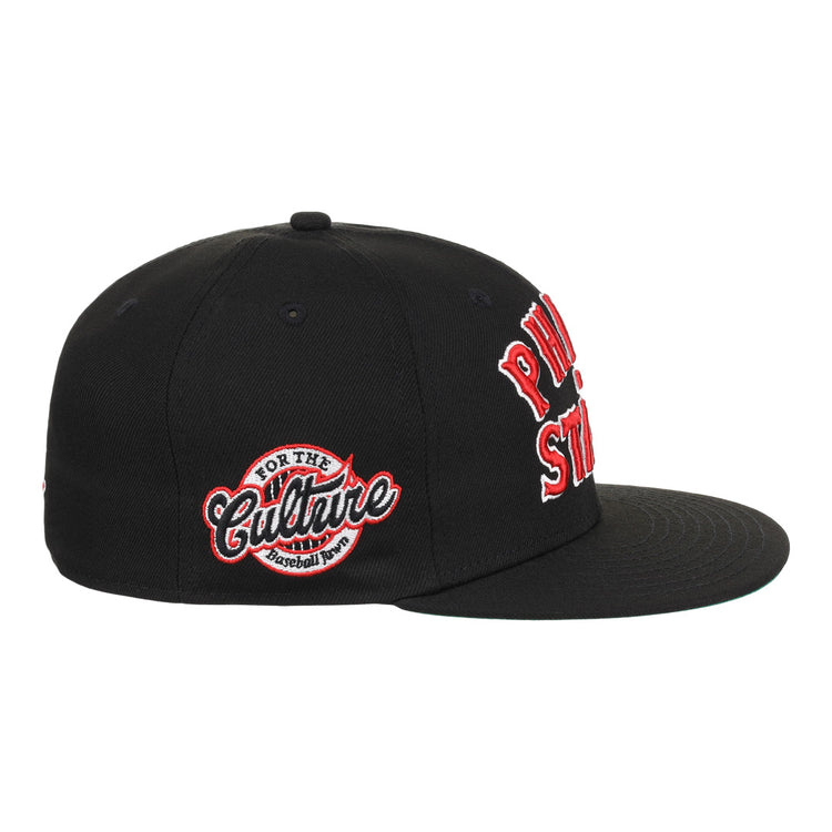 The EFF Cultural Excellence x Philadelphia Stars Fitted Ballcap is a black streetwear cap with red and white embroidery. A side patch reads For The Culture Baseball Tour, nodding to Negro League Baseball, with bold front text.