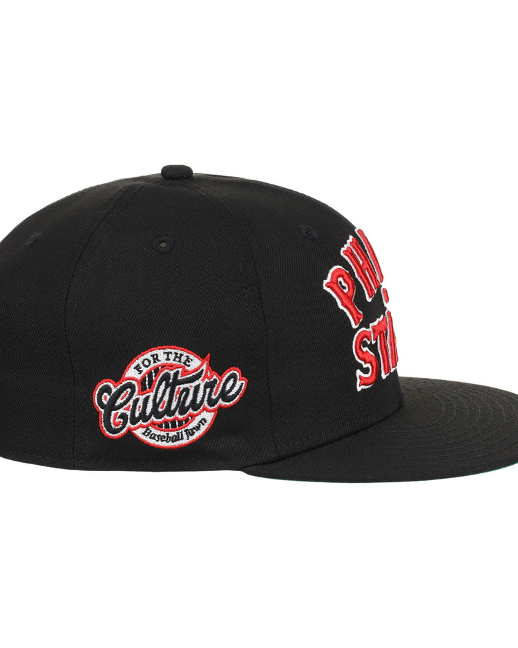 The EFF Cultural Excellence x Philadelphia Stars Fitted Ballcap is a black streetwear cap with red and white embroidery. A side patch reads For The Culture Baseball Tour, nodding to Negro League Baseball, with bold front text.