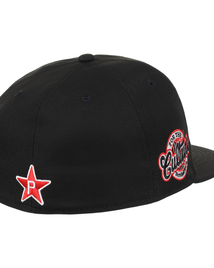 The EFF Cultural Excellence x Philadelphia Stars Fitted Ballcap is black with a red and white star and the letter P, inspired by the Negro League team. It features a circular embroidered Cutters patch on the back and is shown from an angled rear view.