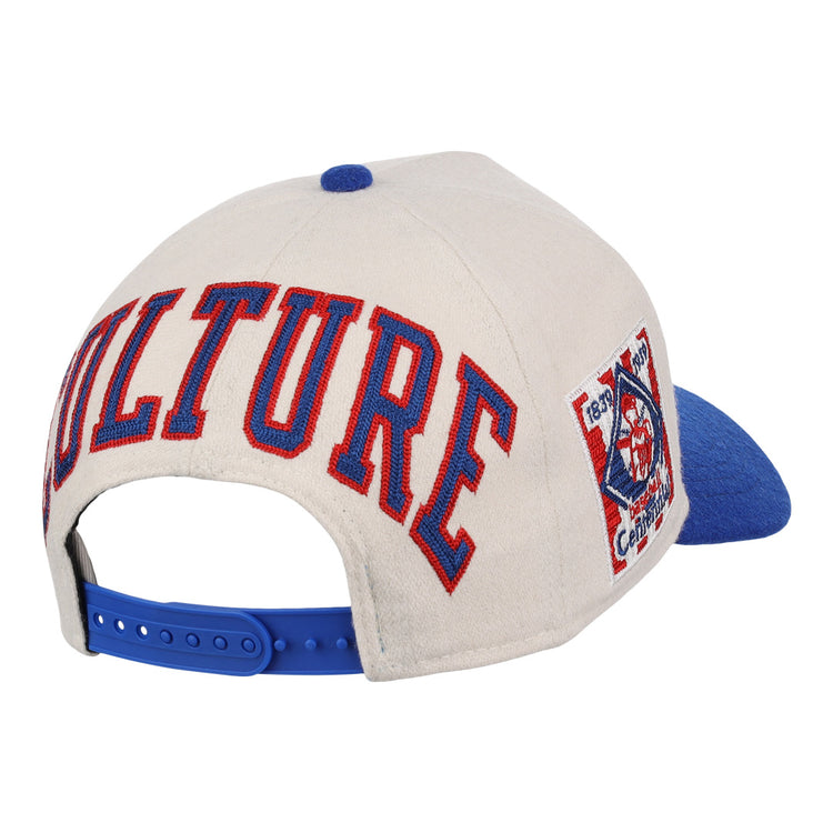 The Ebbets Field Flannels Cultural Excellence x Philadelphia Stars Snapback A-Frame features a beige crown, blue brim and snapback, “CULTURE” in bold red and blue on the back, and a side logo patch inspired by Negro League Baseball streetwear.