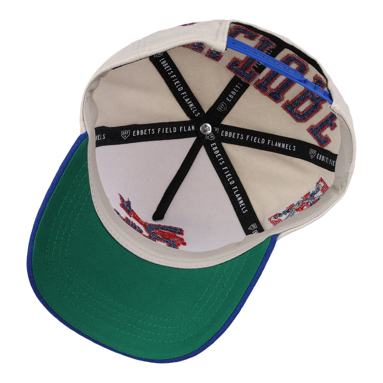 The Cultural Excellence x Philadelphia Stars Snapback A-Frame by Ebbets Field Flannels features a beige inner crown with blue trim, black EBBETS FIELD FLANNELS fabric strips, red stitching, and a classic green underbrim.