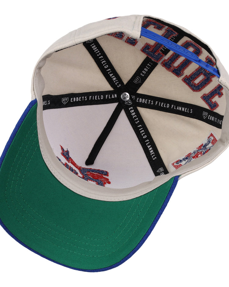 The Cultural Excellence x Philadelphia Stars Snapback A-Frame by Ebbets Field Flannels features a beige inner crown with blue trim, black EBBETS FIELD FLANNELS fabric strips, red stitching, and a classic green underbrim.