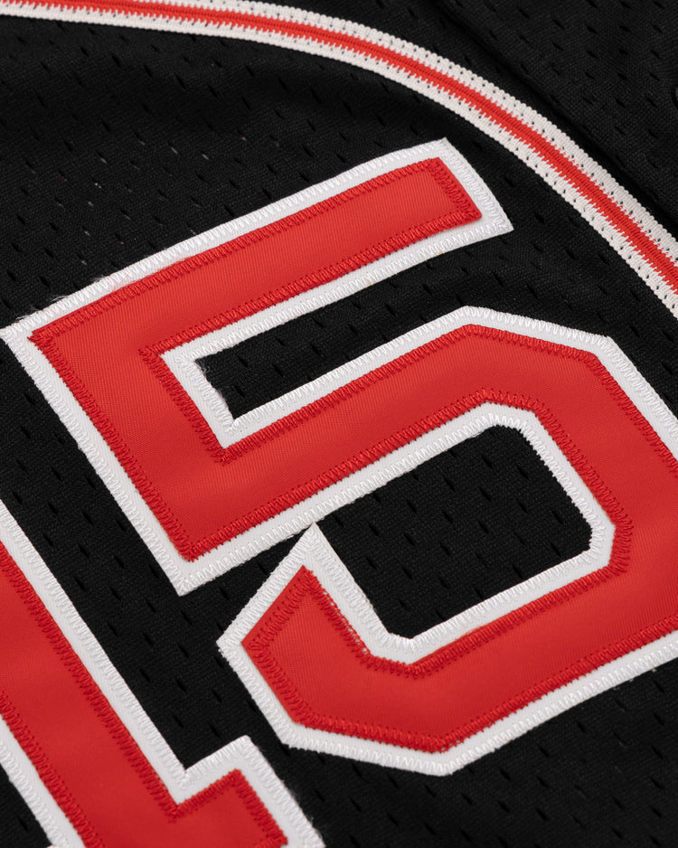 Close-up of the EFF Cultural Excellence x Philadelphia Stars Button Down Jersey, featuring bold red 16 numerals outlined in white on breathable black mesh fabric with perforations for style and comfort.