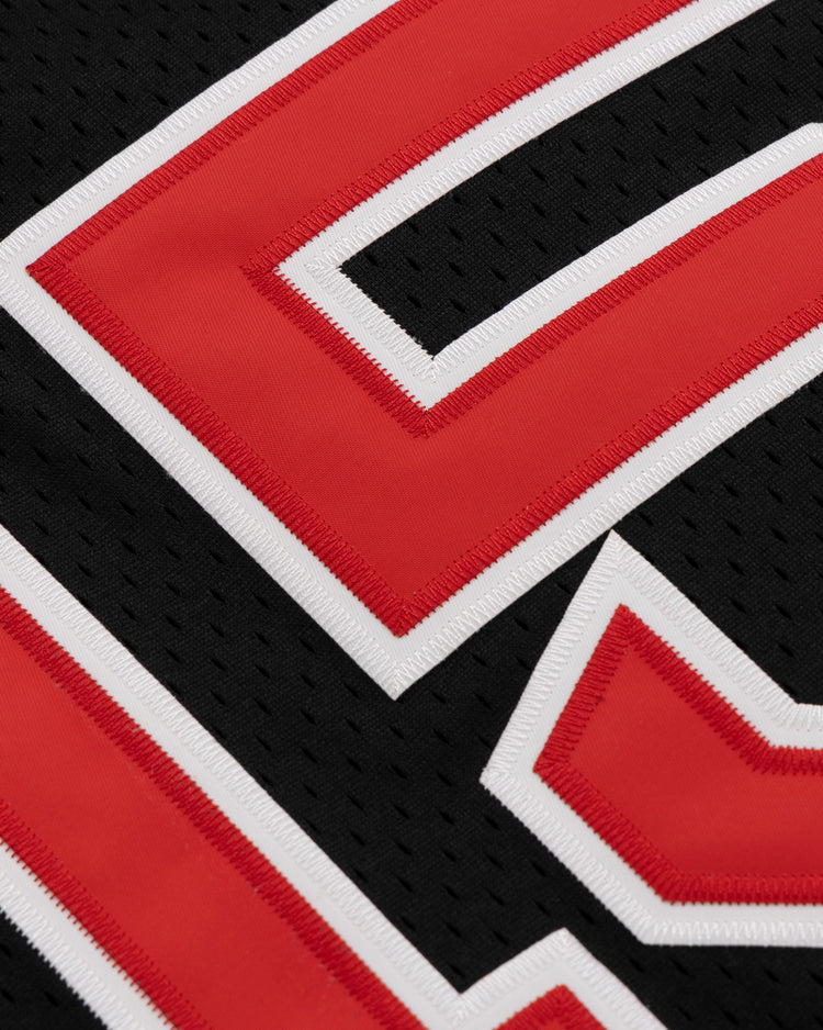 Close-up of the EFF Cultural Excellence x Philadelphia Stars Button Down Jersey, showcasing a black mesh design with red and white-outlined numbers and detailed stitching—honoring Negro League Baseball vintage style in modern streetwear.