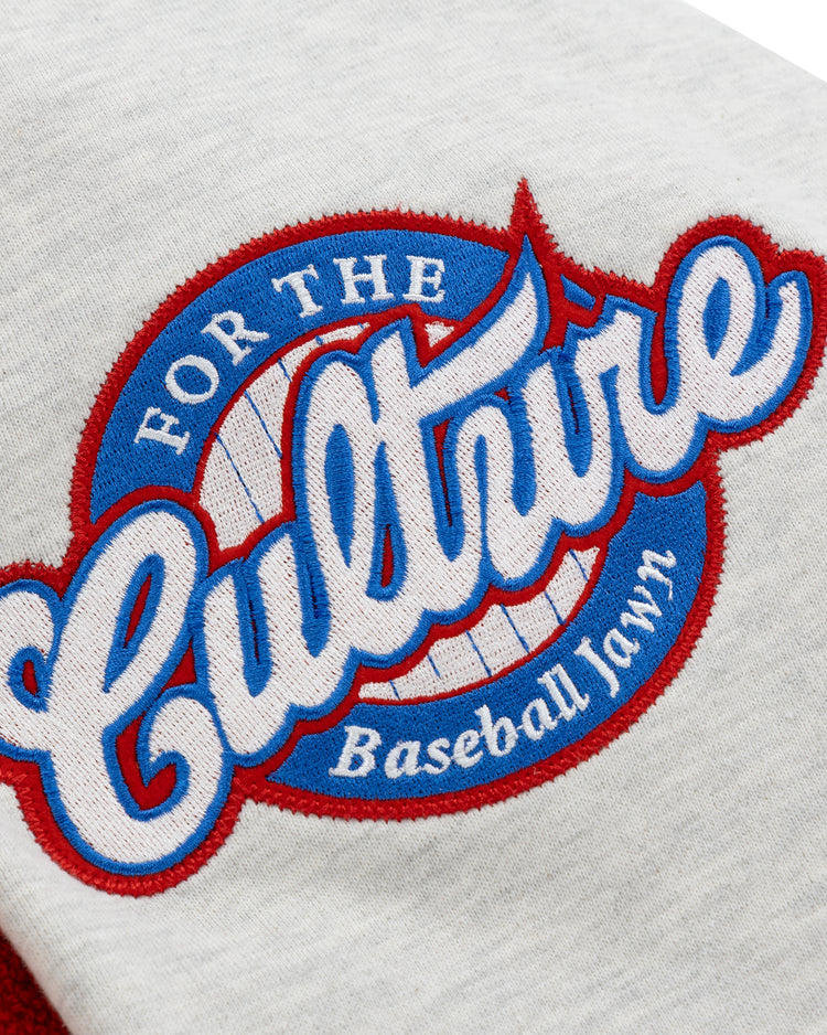 A white fabric patch on the EFF Cultural Excellence x Philadelphia Stars French Terry Hooded Sweatshirt features For the Culture in blue script over a red-bordered baseball, with Baseball Lawn below in bold red and blue stitching.