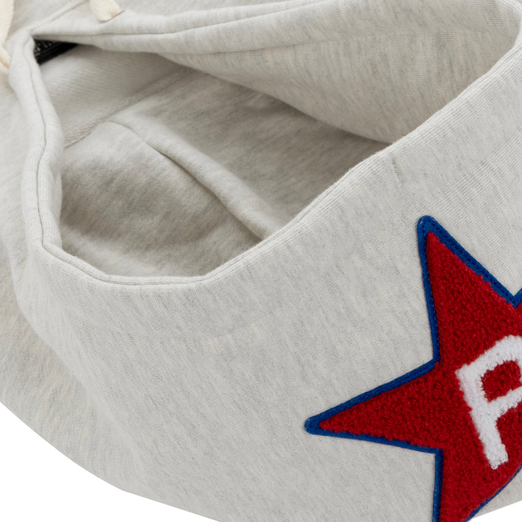 A close-up of the EFF Cultural Excellence x Philadelphia Stars French Terry Hooded Sweatshirt in light gray, with a red star outlined in blue and a white A on the outside, inspired by the iconic Negro League Baseball team.