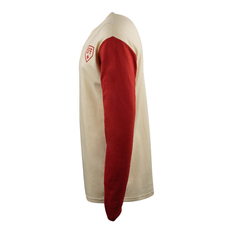 Side view of the EFF Fungo Shirt - Red Sleeves showing a cream body, red sleeves, and a small red and white shield logo on the upper left chest against a plain white background.