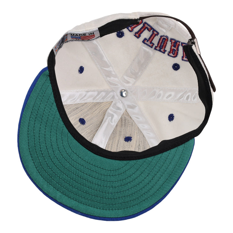 The EFF Cultural Excellence x Philadelphia Stars Wool Ballcap is turned inside out, revealing its interior stitching, a green brim underside, white crown, navy blue ventilations holes, and a MADE IN tag—classic Negro League Baseball style.