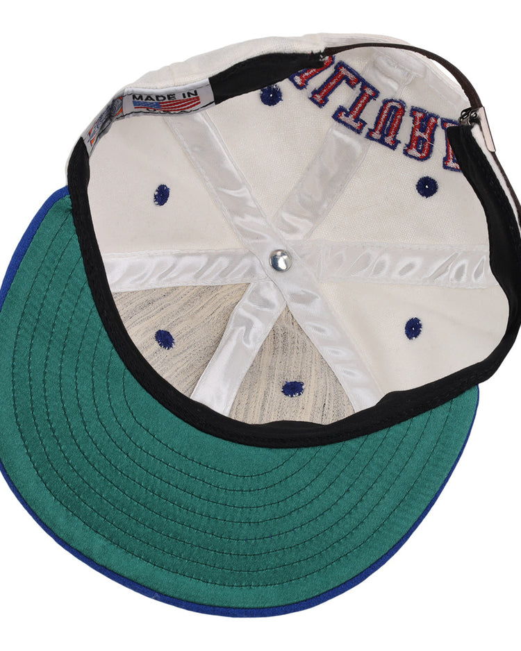 The EFF Cultural Excellence x Philadelphia Stars Wool Ballcap is turned inside out, revealing its interior stitching, a green brim underside, white crown, navy blue ventilations holes, and a MADE IN tag—classic Negro League Baseball style.