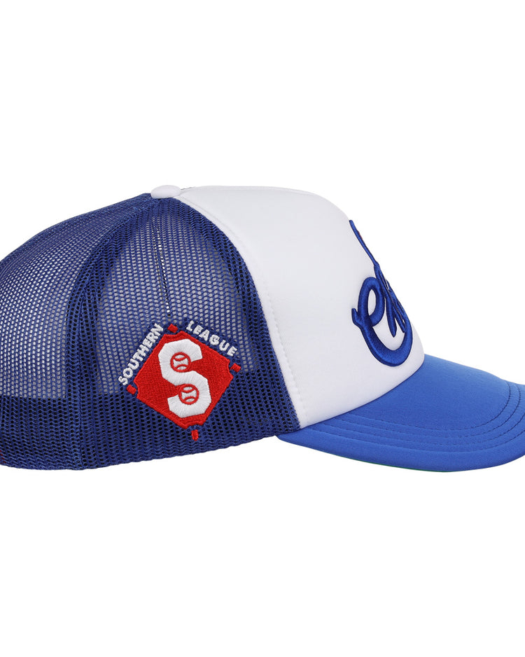 The EFF Memphis Chicks EFF MiLB Vintage Foam Trucker is a blue and white hat with a curved blue brim, a red and white Southern League patch, and cursive blue lettering on the front, inspired by the original Memphis Chicks hat.