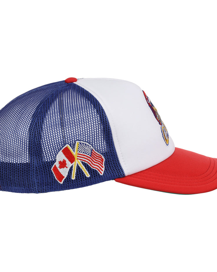 The EFF Calgary Cannons EFF MiLB Vintage Foam Trucker is a blue and white hat with a red brim, featuring crossed Canadian and American flags embroidered on the side mesh—honoring the Pacific Coast League’s Calgary Cannons.