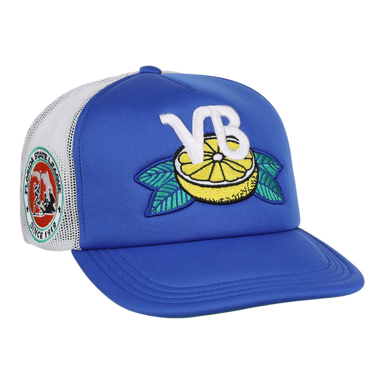 The EFF Vero Beach Dodgers EFF MiLB Vintage Foam Trucker is a blue and white hat featuring a lemon and green leaves patch, large white VB letters, and a colorful round bear patch with Florida State League text.
