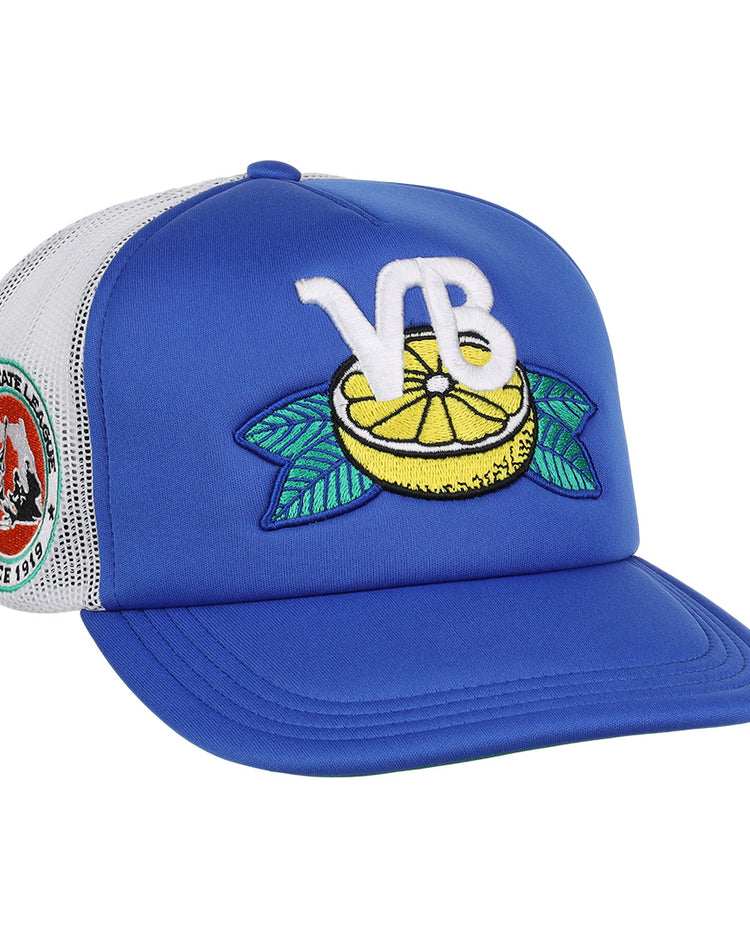 The EFF Vero Beach Dodgers EFF MiLB Vintage Foam Trucker is a blue and white hat featuring a lemon and green leaves patch, large white VB letters, and a colorful round bear patch with Florida State League text.