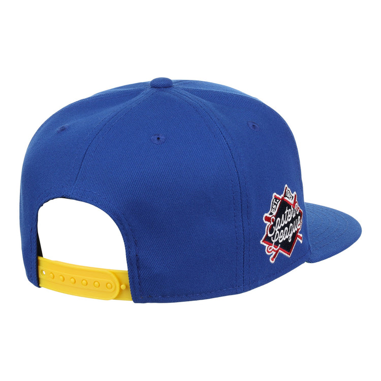 The Vermont Mariners EFF MiLB Vintage Snapback by Ebbets Field Flannels is a blue cap with a yellow adjustable strap and Classic League patch with crossed bats, inspired by the Vermont Mariners. Shown from back and side.