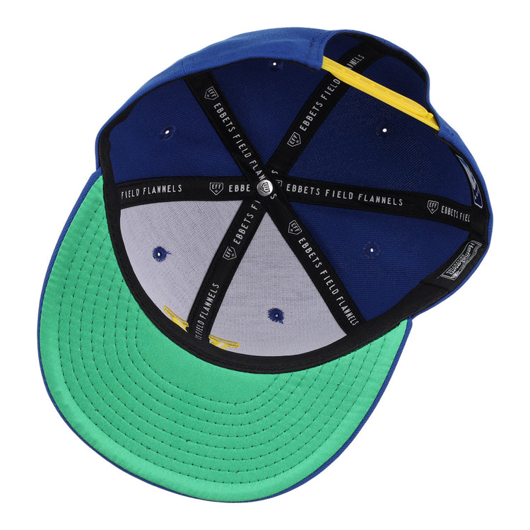The Vermont Mariners Ebbets Field Flannels MiLB Vintage Snapback is a blue adjustable cap with a green brim, black Ebbets Field Flannels lining, white vents, and a yellow accent on the inner band.